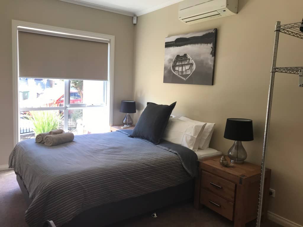 bedroom with window and air conditioner