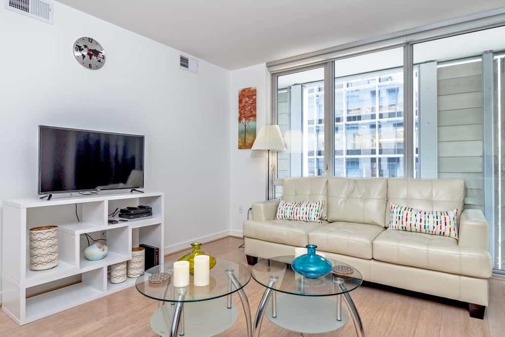 lounge room with tv coffee table and white couch